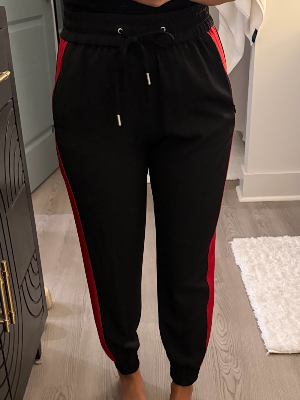 Black silky jogger pants with red stripe